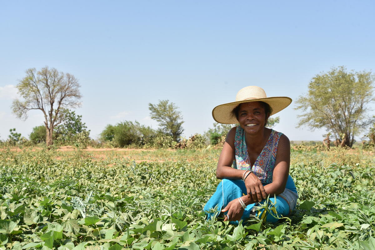 woman kneeling in farm field