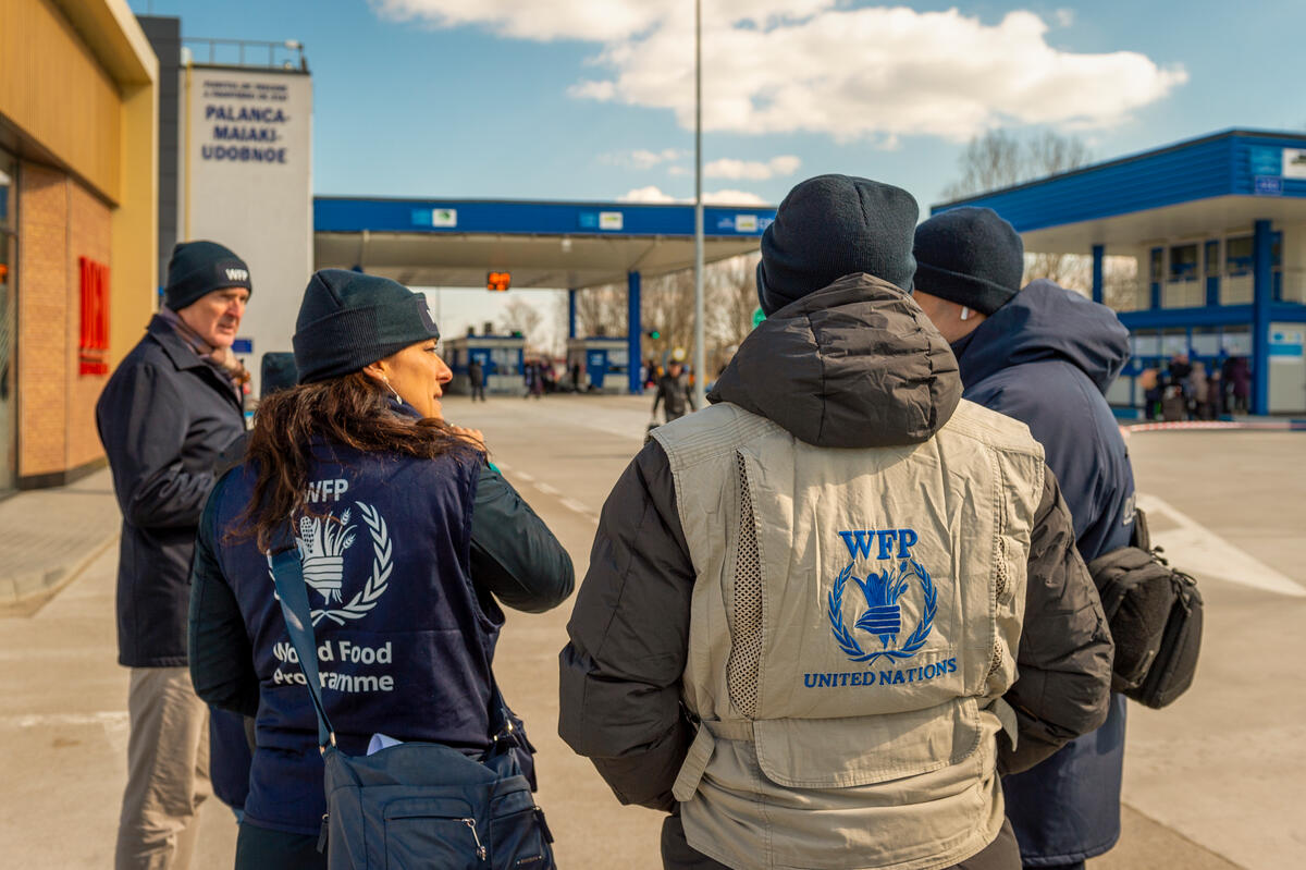 men and women in WFP vests walking