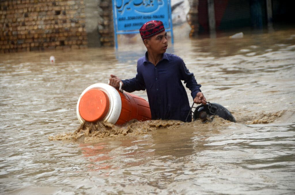 Boy wades through flooded water