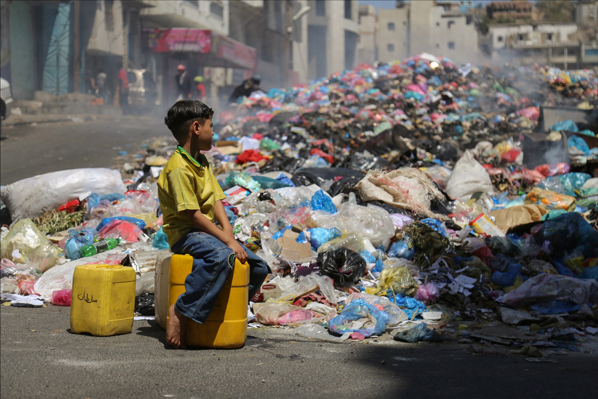 People under siege inside Taiz city pile and burn their garbage on a main road after access to the garbage dump on the outskirts of the city was blocked due to the ongoing fighting.