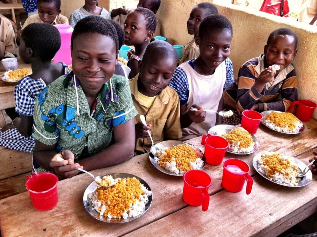 Children enjoy school meals in the classroom