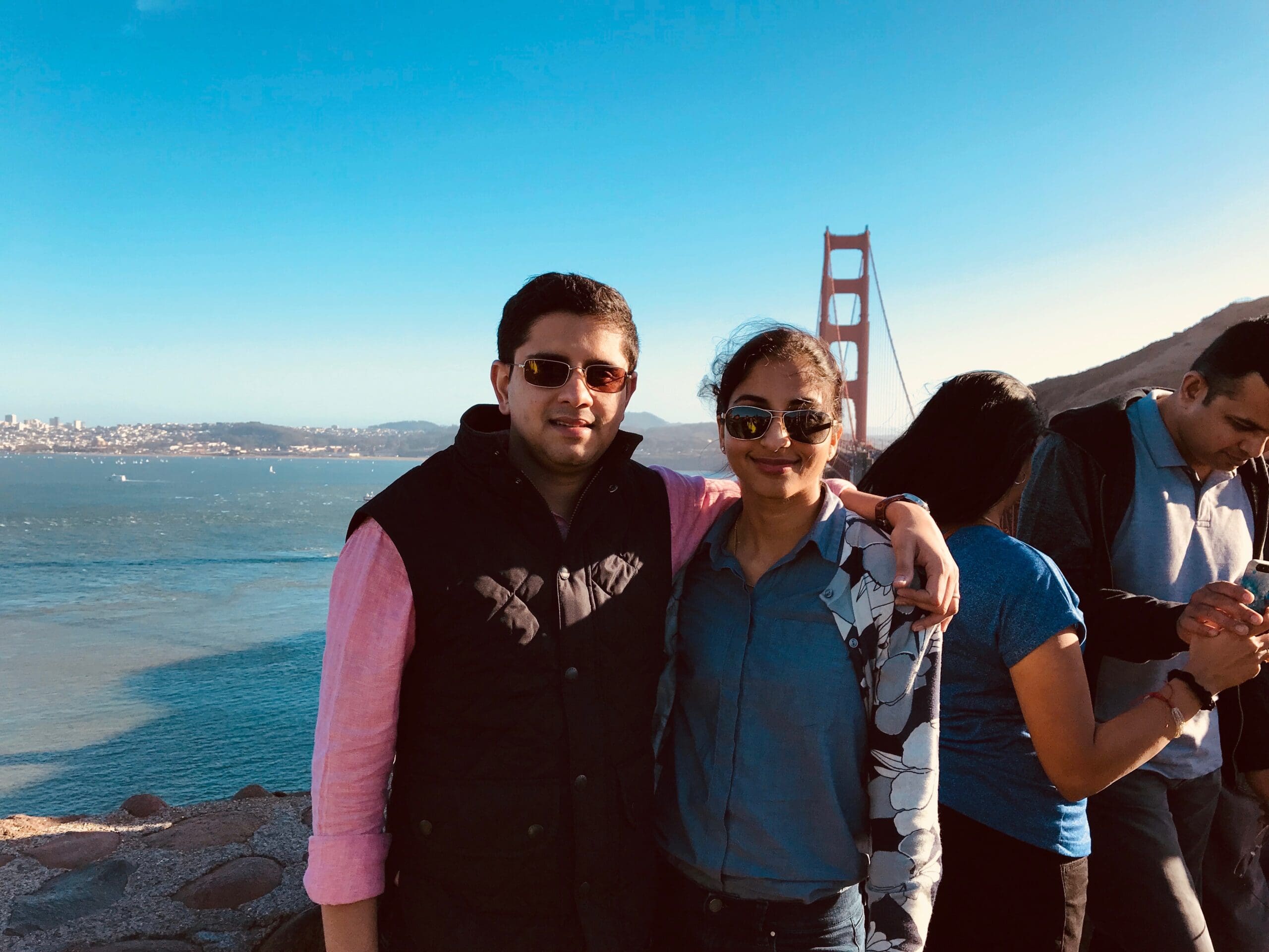 man and woman standing in front of golden gate bridge