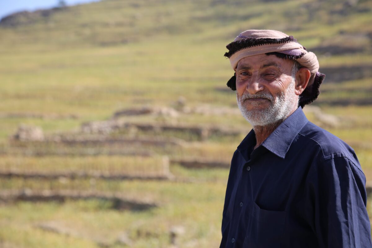 male farmer standing in green field