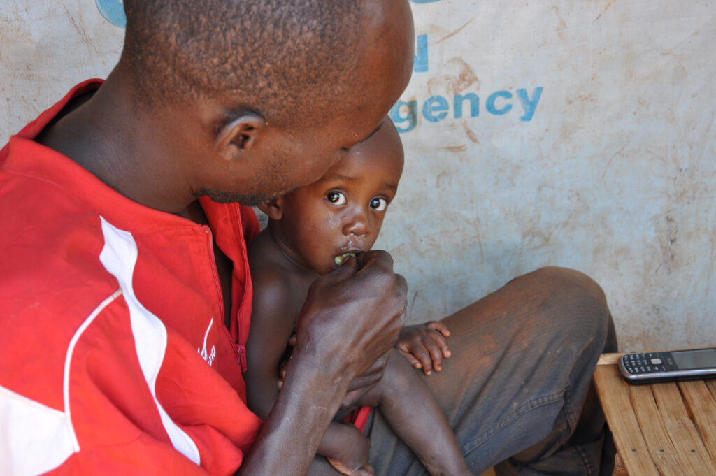 a father feeds his baby by hand