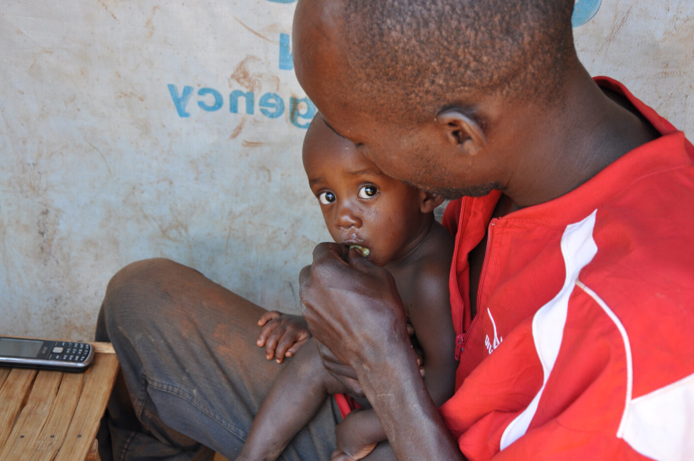 a father feeds his baby by hand