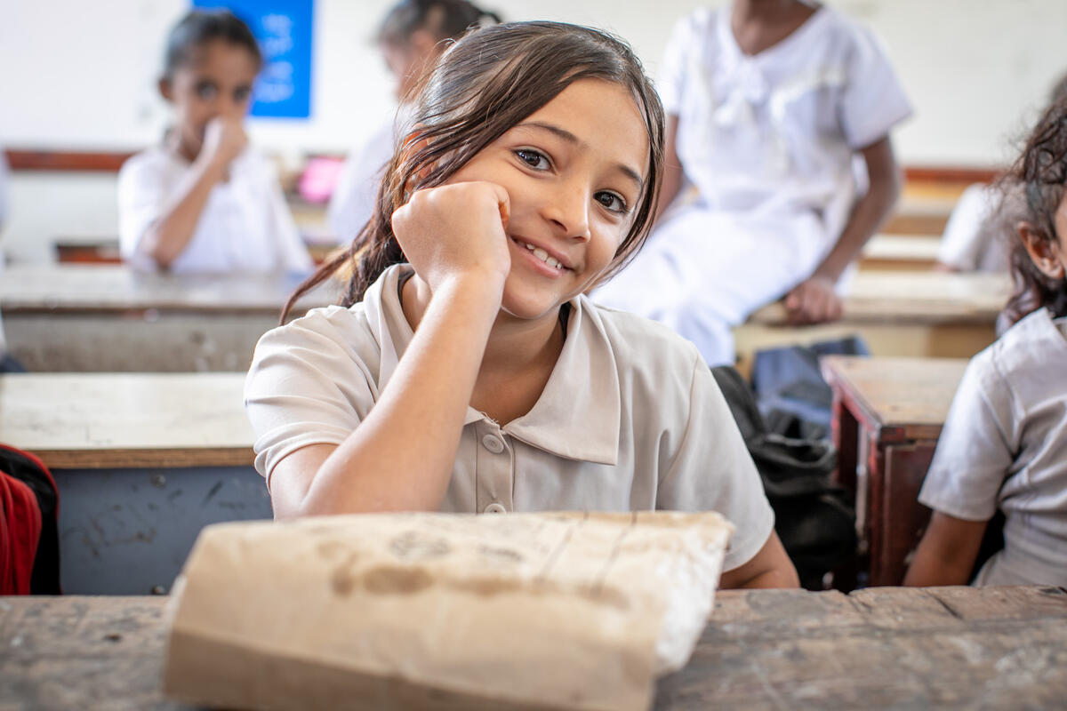 schoolgirl in white shirt eating school meal