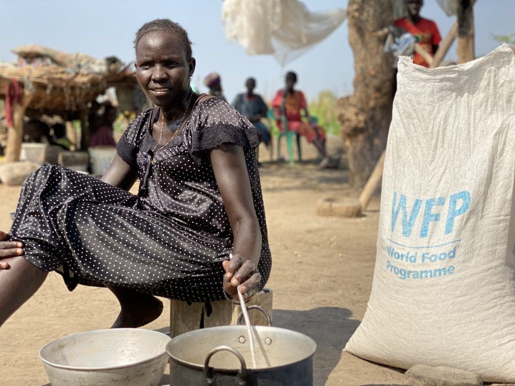 a woman stirs food in a pot