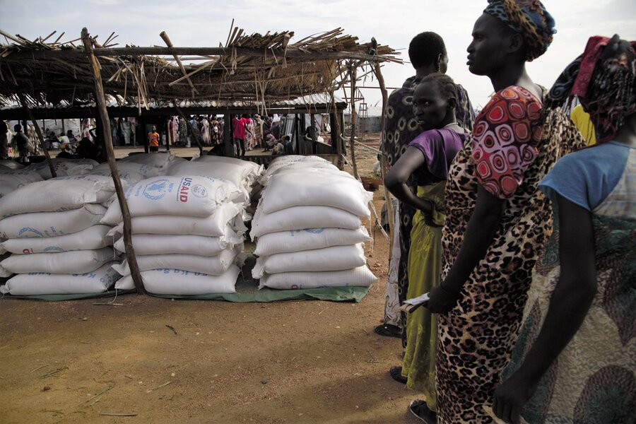 women stand on line for food