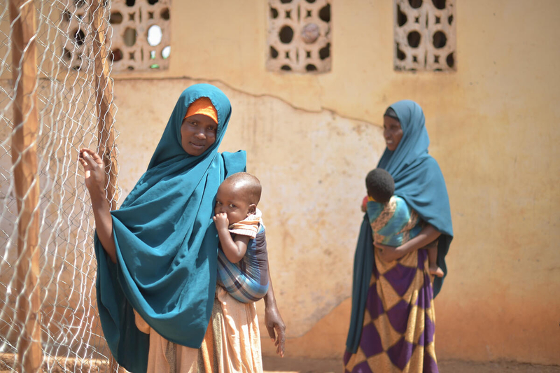 Women holding children in a UN WFP center for malnutrition in a refugee camp in Somalia