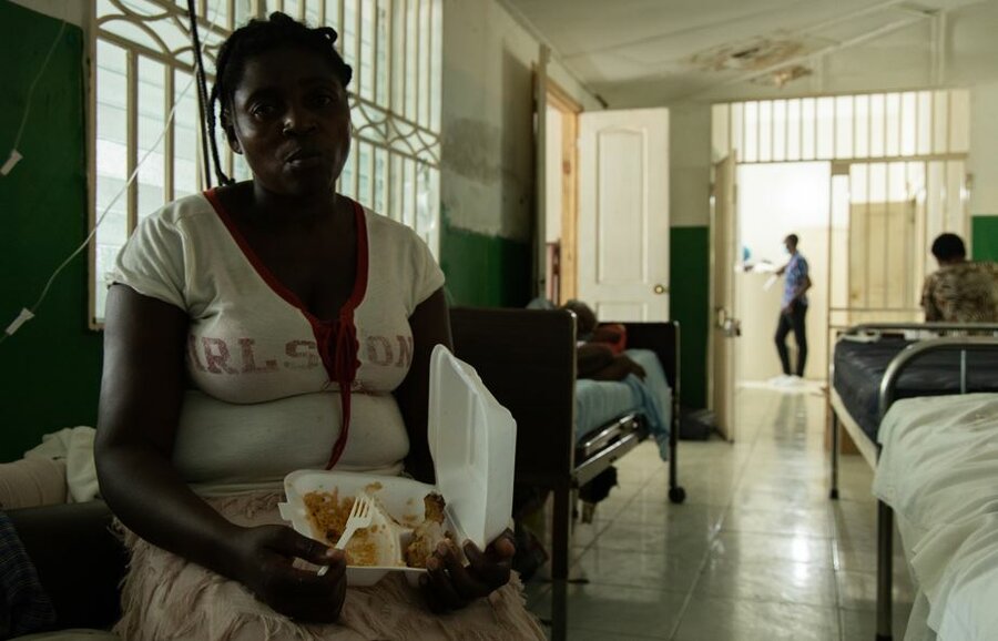woman eating hot meal in health facility