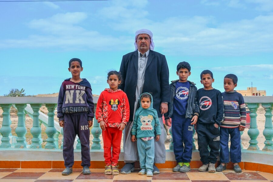 man standing with many children
