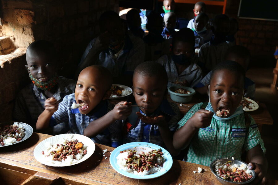 schoolboys eating lunch at table