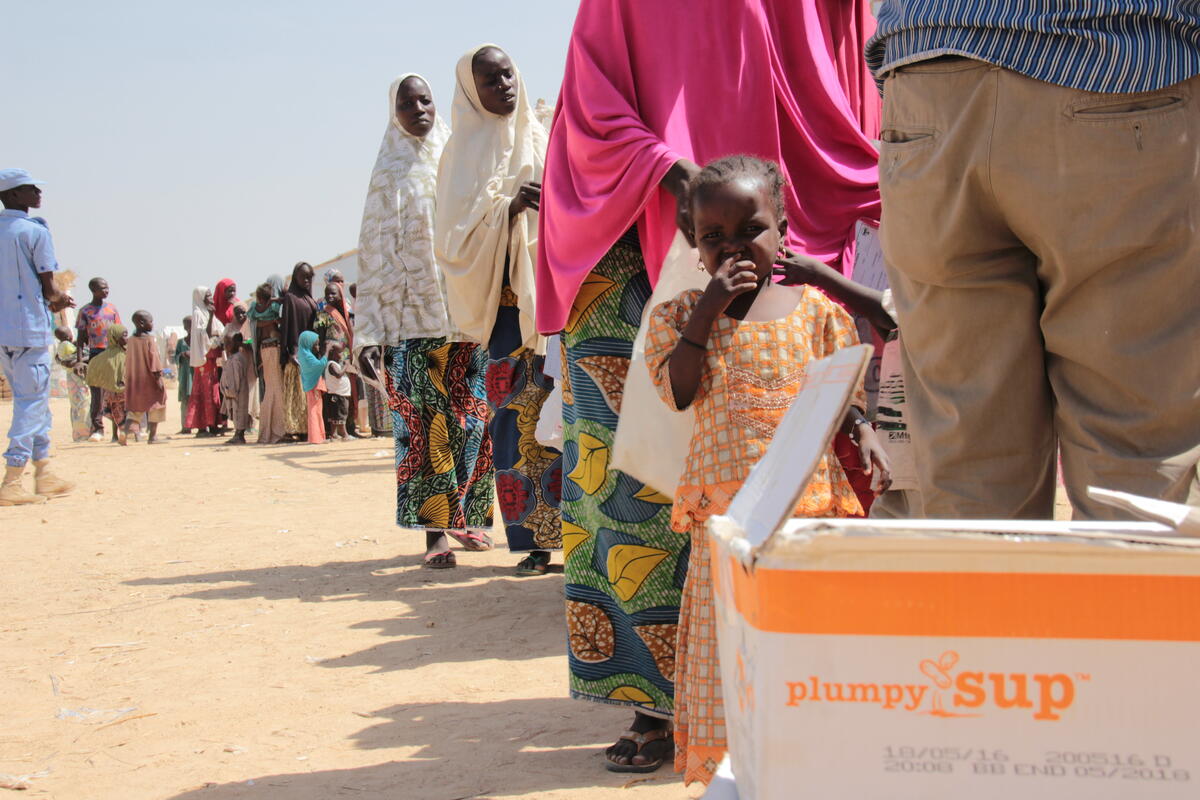 people wait on line for food