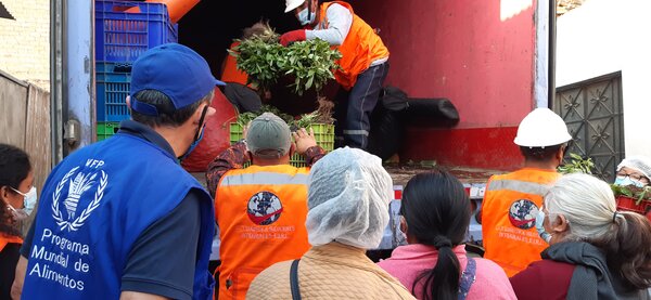 people unloading vegetables from truck