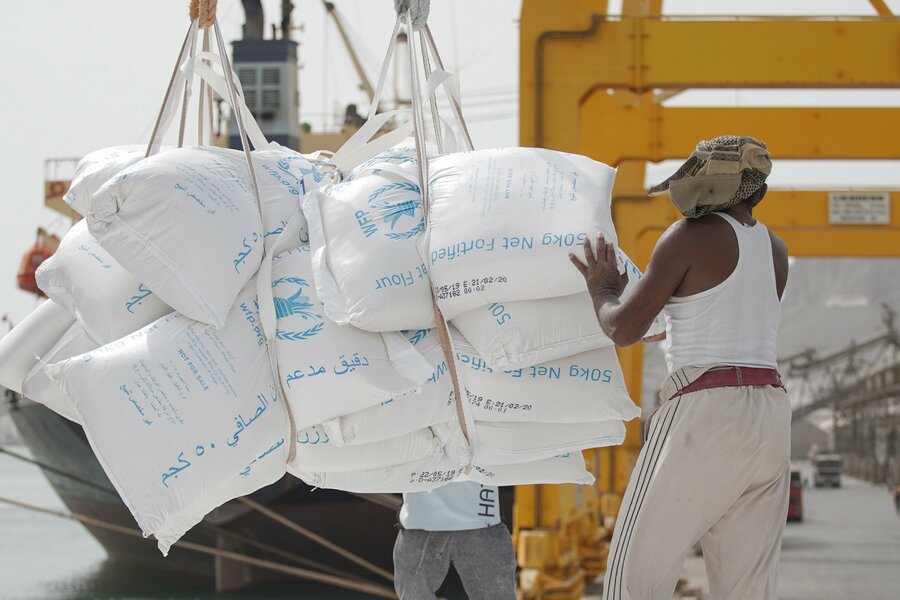 man lifting bags of food