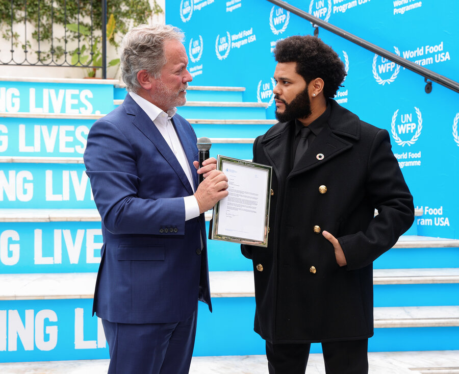 two men speaking on blue stairs