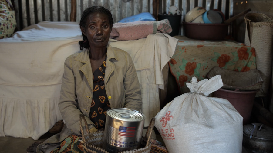 woman sitting next to bags of food