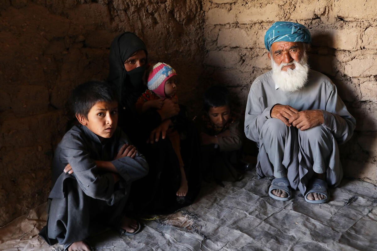 family sitting on floor of home