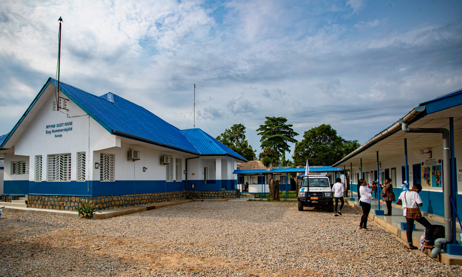 blue and white building next to trucks