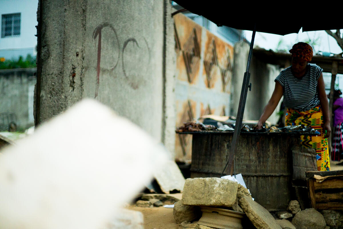 woman reaching for food in market