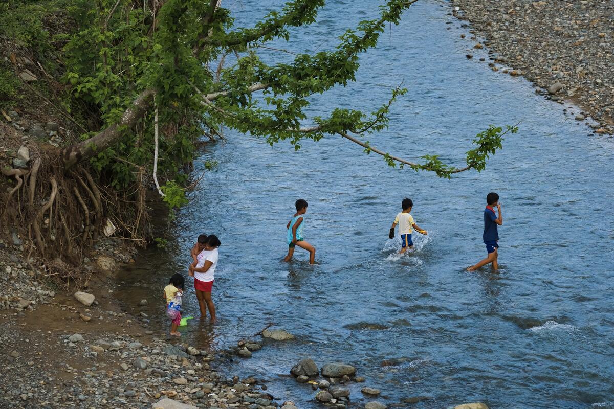 family wading through flooded waters