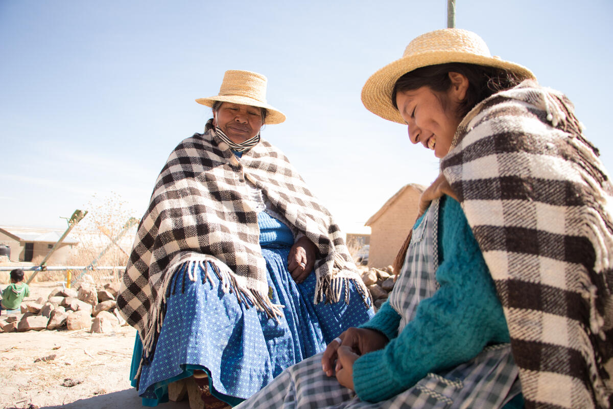 man and women in blanket wraps and straw hats