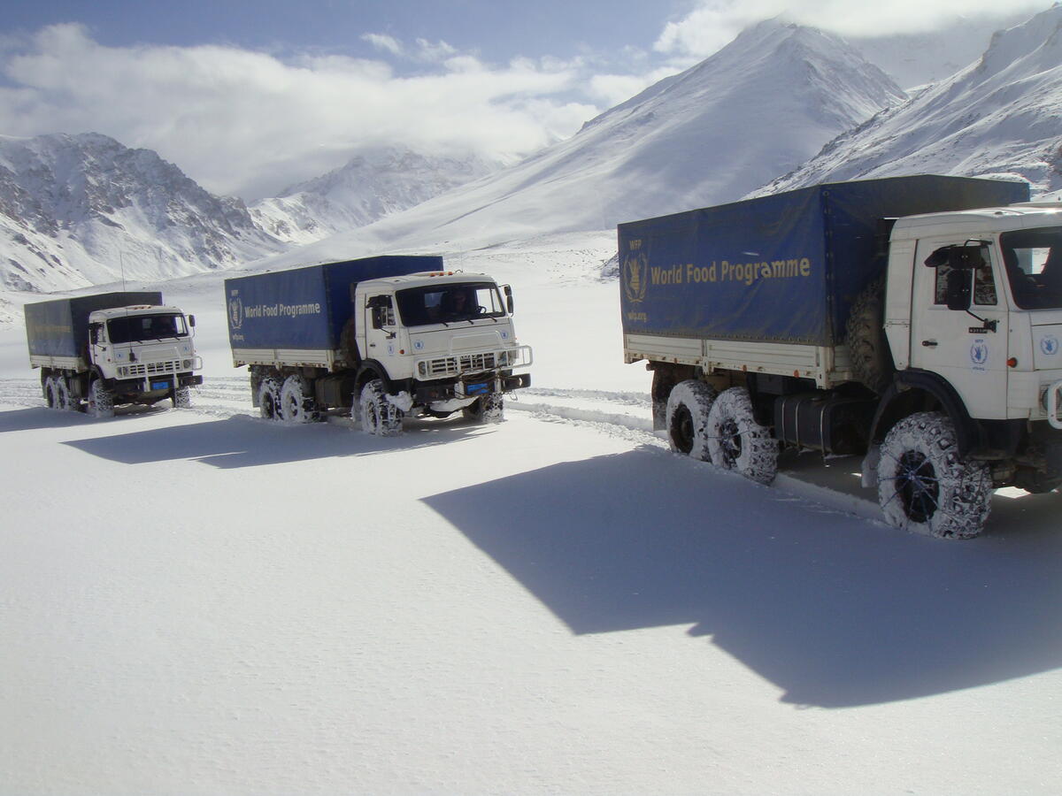 WFP blue and white trucks driving in snowy region