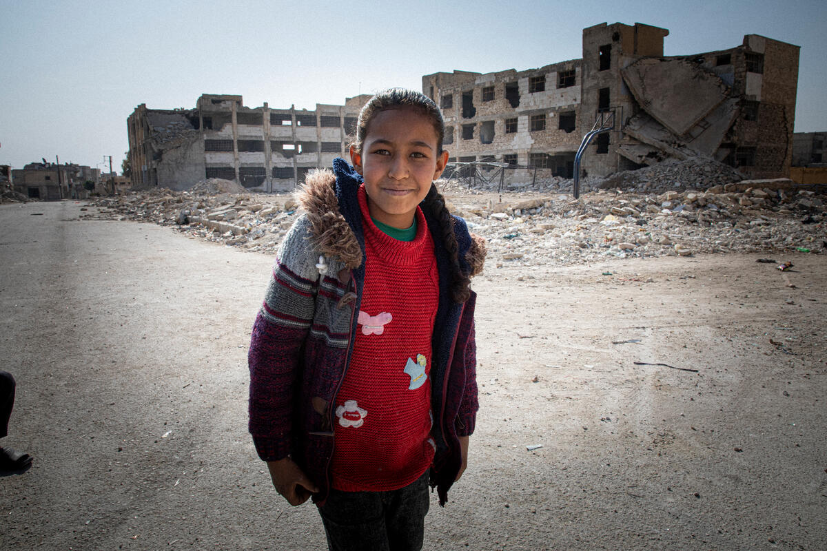 girl in red sweater and jacket walking to school