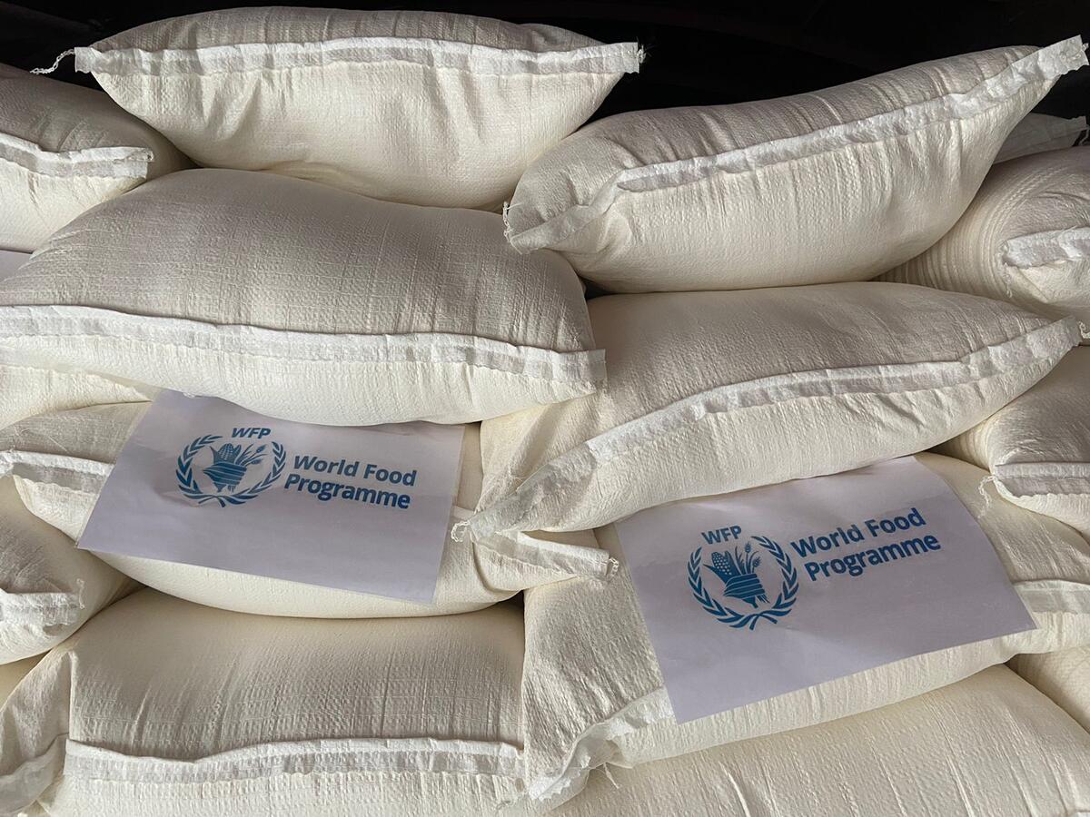 white bags of food with WFP logo