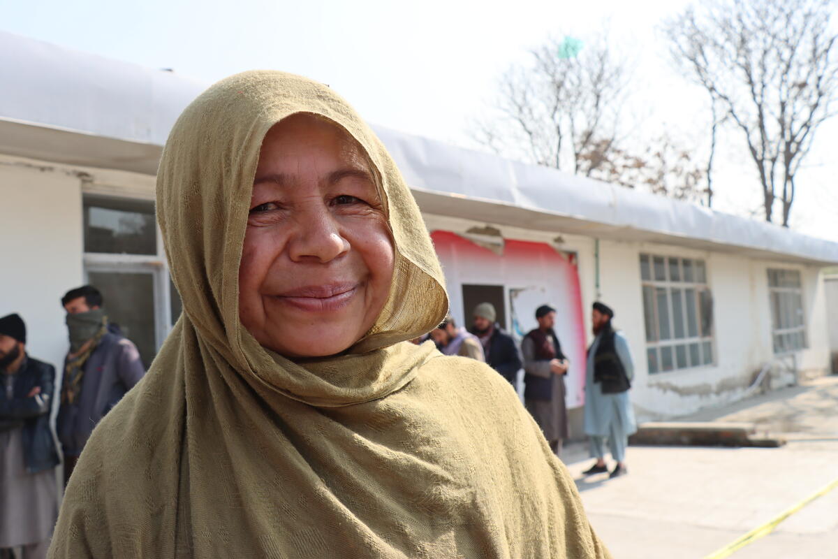 woman in green headscarf smiling