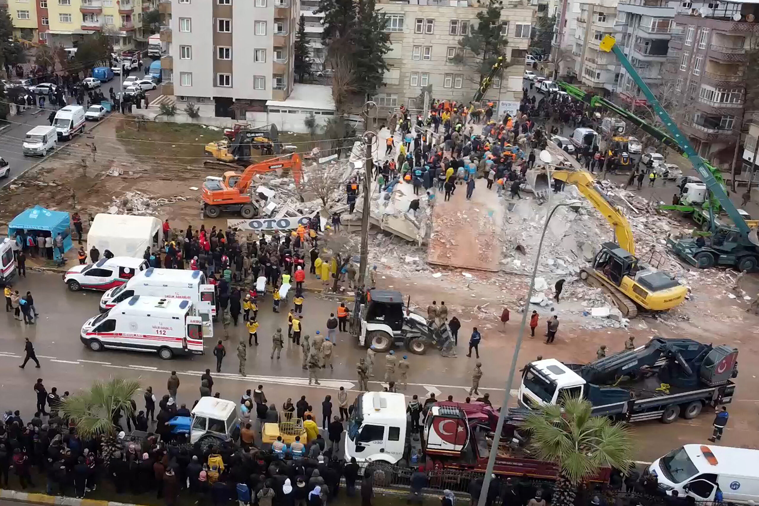 rescuers search for survivors through the rubble