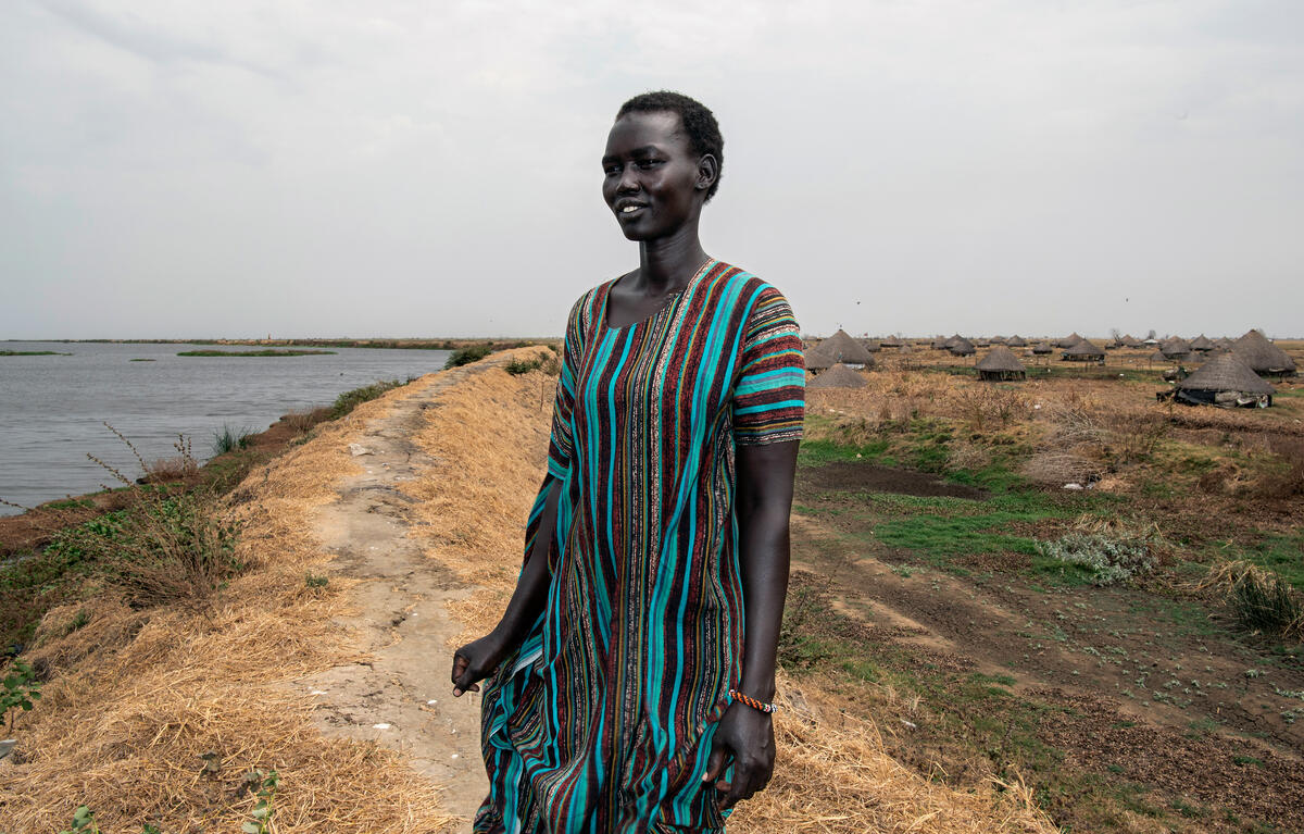 Woman stands on dyke in South Sudan