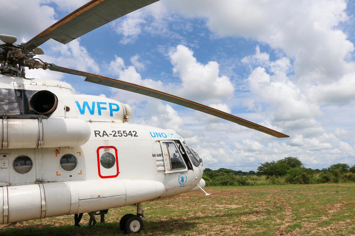 WFP UNHAS helicopter in green field